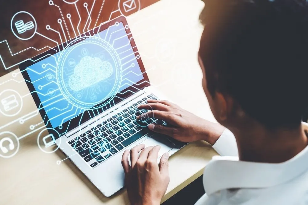 A managed IT professional sits at a computer terminal.