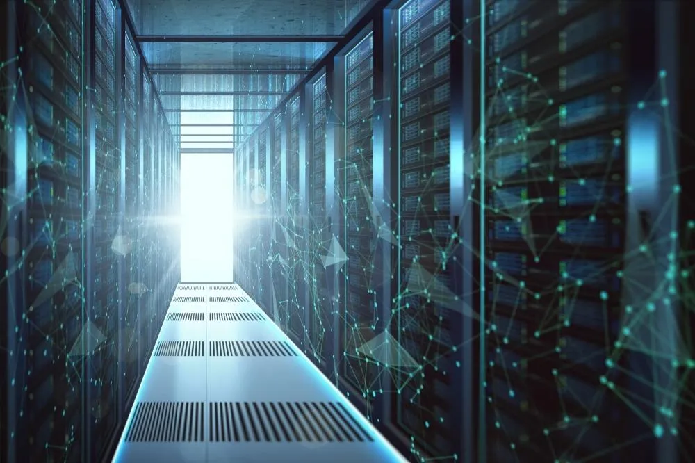 A managed IT professional operates in a long row of servers at a data farm.