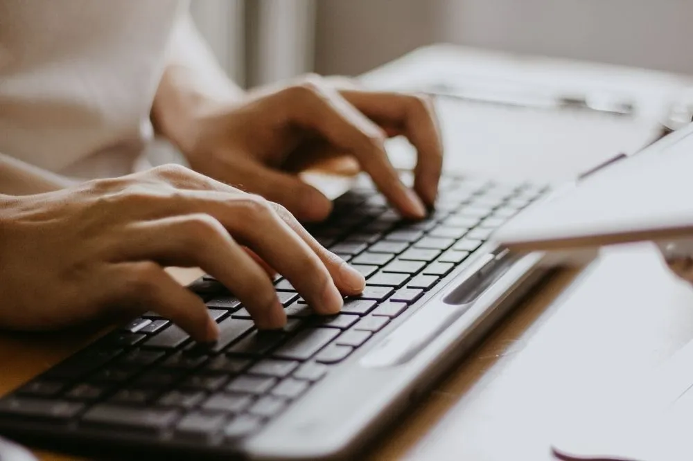 A managed IT expert sits at a computer terminal working on client data.