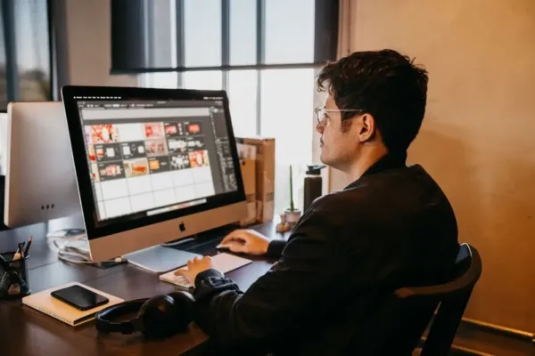 A managed IT professional sits at a client's desk after getting the system up and running.